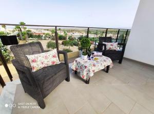 a patio with two chairs and a table with a table at Villa Don Pedro in Gran Alacant