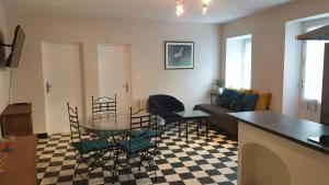 a living room with a glass table and chairs at LE CLOS DES COLVERTS in Campagne-sur-Aude +12 photos