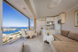
a hotel room with a balcony overlooking the ocean at Apartments Dilberovic in Dubrovnik
