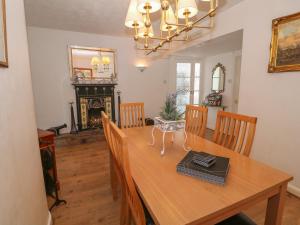 a dining room with a wooden table with chairs at Beachway in Holywell
