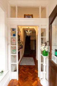 a hallway of a home with a chandelier at The Carlton in Blackpool