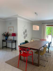 a dining room with a wooden table and chairs at Sleep & Surf Ericeira - Portugal in Ericeira