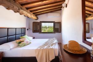 a bedroom with a bed with a hat on it at Borgo Verde in Vada