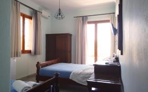 מיטה או מיטות בחדר ב-Fistiki Rooms