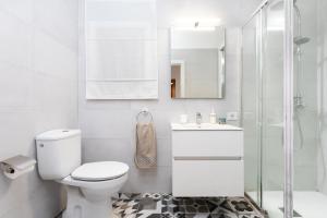 a bathroom with a toilet and a sink and a shower at Home2Book Playa Chica Paradise Santa Cruz in Santa Cruz de Tenerife +25 photos