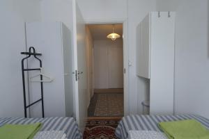 a room with two beds and a hallway with a door at Apartment Turku City Center in Turku