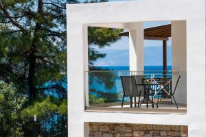 a white house with a view of the ocean at Villa Victoria by La Scala Beach in Limenas
