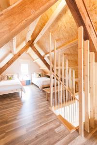 a bedroom with two beds and a staircase in a attic at Catapeixe Holiday Apartments in Redondela