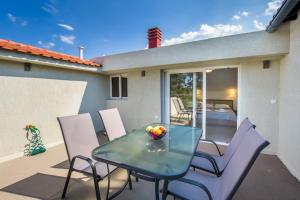 a glass table and chairs on a patio at Haus Sofi in Pefkari
