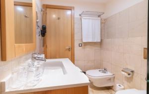 a bathroom with a sink and a toilet at Hotel LIVVO Corralejo Beach in Corralejo