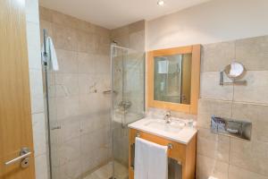 a bathroom with a sink and a shower at Hotel LIVVO Corralejo Beach in Corralejo