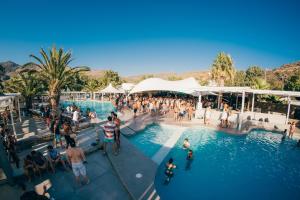 a group of people in a pool at a resort at FarOut - BeachResort & Camping in Mylopotas