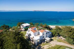 an aerial view of a house on a hill next to the ocean at Villa Victoria by La Scala Beach in Limenas