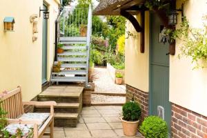 an outdoor pathway with stairs and a blue door at Bentley Rise in Lyme Regis