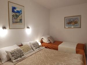 two beds in a small room with two beds at Apartments Abjanic in Dubrovnik