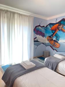 a bedroom with a mural of a boy on a skateboard at Sleep & Surf Ericeira - Portugal in Ericeira