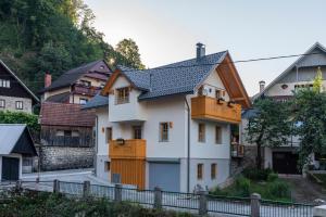 a white house with a black roof at Holiday house Zupanc in Bohinj