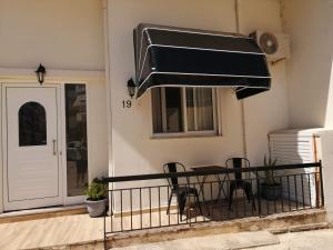 a patio with a table and chairs on a balcony at Speri's Loft in Preveza