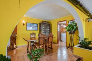 a dining room with yellow walls and a table and chairs at Villa Casa Concha in Teguise