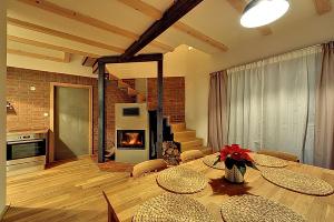 a dining room with a table and a fireplace at Apartmány no.823 in Bublava