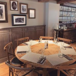 a wooden table with wine glasses on top of it at L'Annexe in Val dʼIs&egrave;re