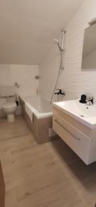 a bathroom with a tub and a toilet and a sink at Apartments Katarina in Stara Novalja
