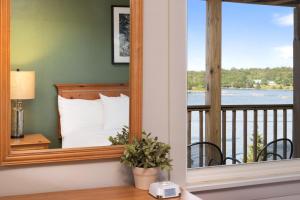 a mirror in a room with a bed and a balcony at Ocean Gate Resort in Southport