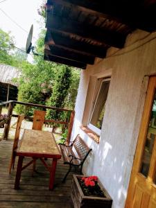 a patio with a table and chairs on a porch at Pensjonacik Gafel in Ruciane-Nida