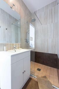 a bathroom with a white sink and a shower at Breathtaking luxurious villa with sea-view in Théoule sur Mer in Théoule-sur-Mer