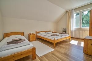 A bed or beds in a room at Villa Harmónia Panzió