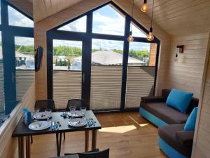 a living room with a table and a couch at Rainbow Resort in Jastrzębia Góra