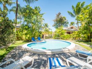 a pool with chaise lounge chairs and a resort at Résidence Villas Les Hibiscus in Las Terrenas
