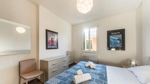 a bedroom with a bed and a chair in it at Residenza Canal in Venice