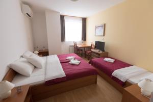 Postel nebo postele na pokoji v ubytování Hotel Klek