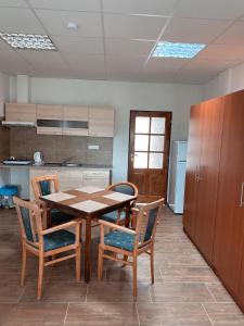 a kitchen with a table and chairs in a room at Ubytovani Vysocany in Bor