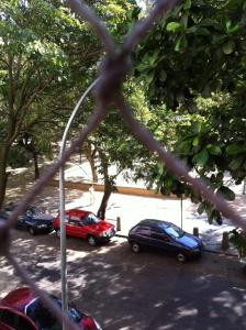 a group of cars parked in a parking lot at Bucolico Apartamento em Copacabana in Rio de Janeiro