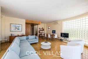 アルブフェイラにあるVilla AcquaMarina - 5 bedroom, water front villaのリビングルーム(青いソファ、テレビ付)