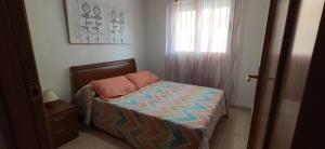 a small bed in a room with a window at Costa Marina I, 1ª linea, 4ª planta, Norte in Oropesa del Mar +24 photos