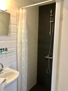 a bathroom with a shower and a sink at Hotel Grandcafe De Doelen in Franeker