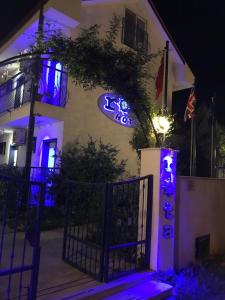 a sign on the side of a building with purple lights at Rota Hotel in Dalyan