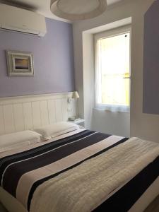 a bedroom with a large bed with a window at La Linea D'Acqua in Manarola