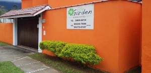 an orange building with a sign on the side of it at VILLA GARDEN - Suites in Maresias