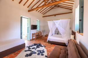 a bedroom with a bed and a couch in a room at Casa Barichara Boutique in Barichara