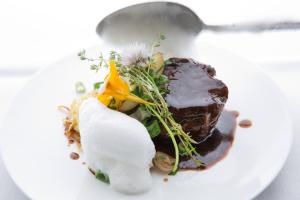 a white plate with a piece of food on it at Boutique Hotel Hohes Licht in Damuls