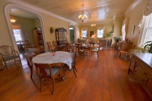 a dining room with tables and chairs in a room at The Bed and Breakfast at Oliver Phelps in Canandaigua