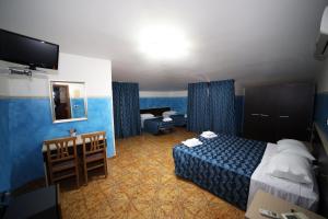 Postel nebo postele na pokoji v ubytování Hotel Napoleone