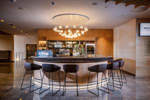 a bar in a restaurant with black stools at Hotel Park - Sava Hotels & Resorts in Bled