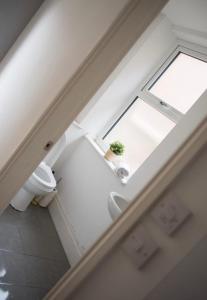 a bathroom with a window and a toilet at Buchanan House Sasco Apartments in Blackpool