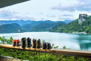a row of shoes sitting on a bench overlooking a lake at Hotel Park - Sava Hotels & Resorts in Bled