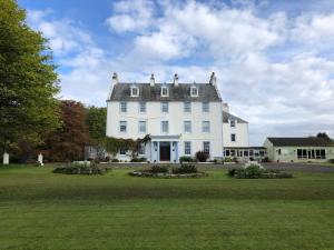 a large white house with a large yard at Forse of Nature in Latheron